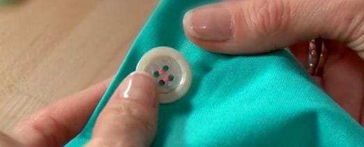 Sew buttons on headbands with a needle to support healthcare heroes
